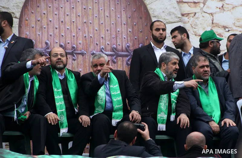 Hamas chief Khaled Meshaal, with senior Hamas leaders, takes part in a Hamas rally marking the 25th anniversary of the Islamist movement's founding in Gaza City on December 8, 2012. Meshaal arrived to Gaza strip on Decem...