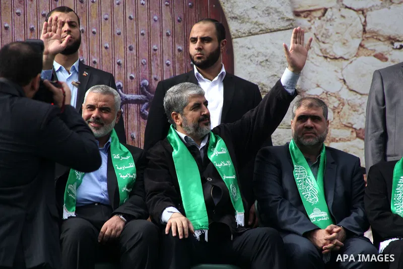 Hamas chief Khaled Meshaal, with senior Hamas leaders, takes part in a Hamas rally marking the 25th anniversary of the Islamist movement's founding in Gaza City on December 8, 2012. Meshaal arrived to Gaza strip on Decem...