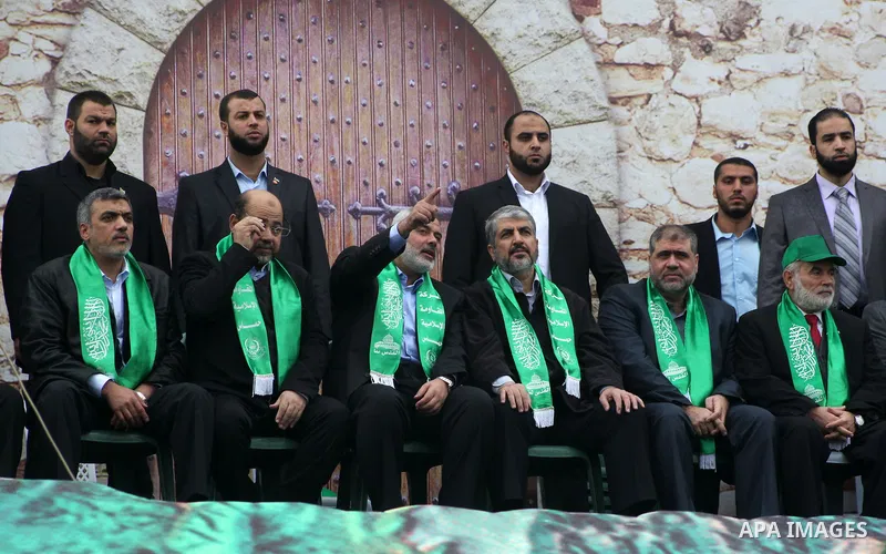 Hamas chief Khaled Meshaal, with senior Hamas leaders, takes part in a Hamas rally marking the 25th anniversary of the Islamist movement's founding in Gaza City on December 8, 2012. Meshaal arrived to Gaza strip on Decem...