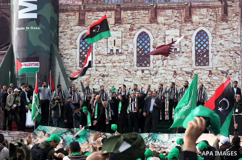Hamas chief Khaled Meshaal, with senior Hamas leaders, takes part in a Hamas rally marking the 25th anniversary of the Islamist movement's founding in Gaza City on December 8, 2012. Meshaal arrived to Gaza strip on Decem...