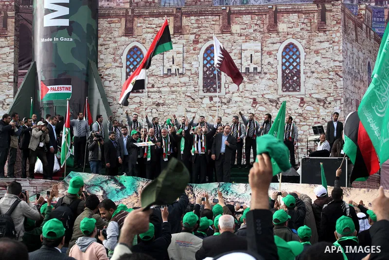 Hamas chief Khaled Meshaal, with senior Hamas leaders, takes part in a Hamas rally marking the 25th anniversary of the Islamist movement's founding in Gaza City on December 8, 2012. Meshaal arrived to Gaza strip on Decem...