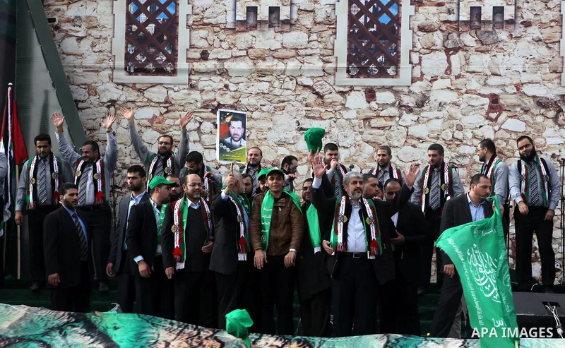 Hamas chief Khaled Meshaal, with senior Hamas leaders, takes part in a Hamas rally marking the 25th anniversary of the Islamist movement's founding in Gaza City on December 8, 2012. Meshaal arrived to Gaza strip on Decem...