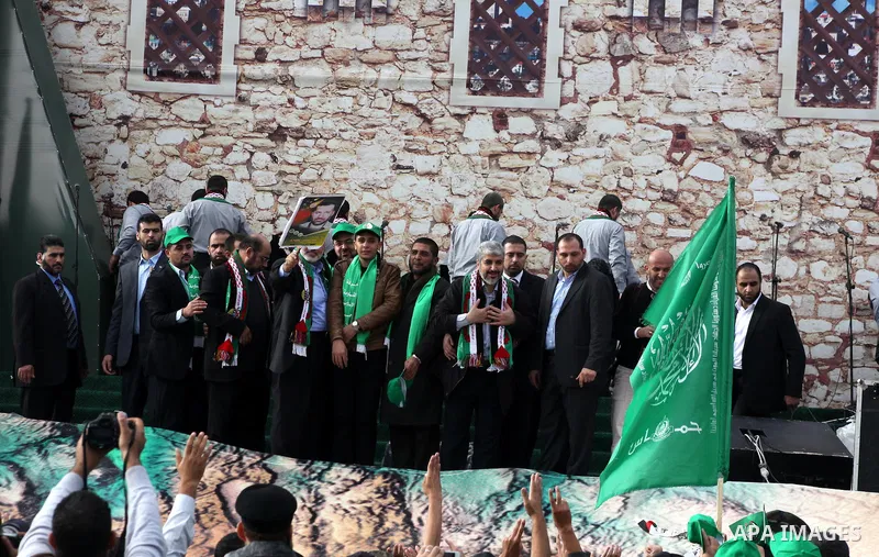 Hamas chief Khaled Meshaal, with senior Hamas leaders, takes part in a Hamas rally marking the 25th anniversary of the Islamist movement's founding in Gaza City on December 8, 2012. Meshaal arrived to Gaza strip on Decem...