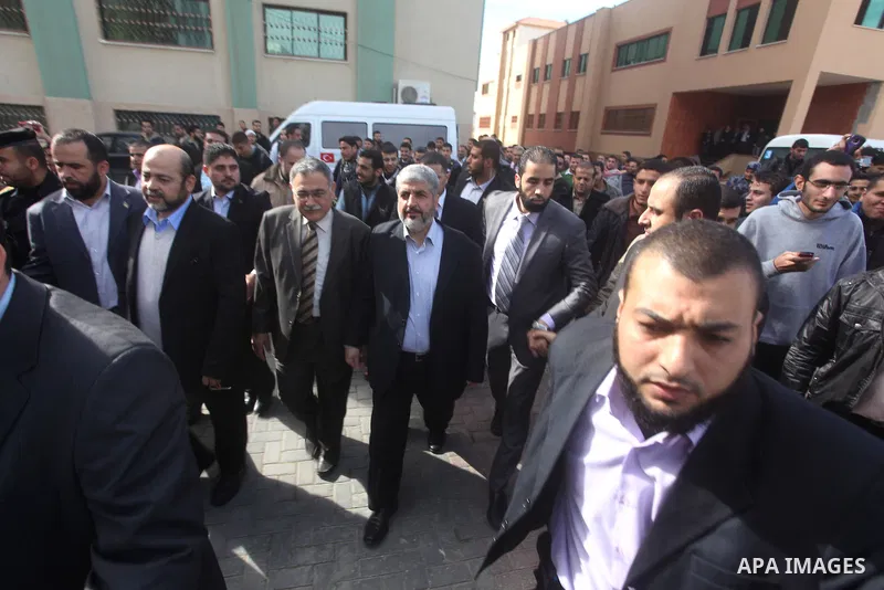 Hamas chief Khaled Meshaal, is greeted during his visit to the Islamic University in Gaza City December 9, 2012. Meshaal, in a defiant speech during his first ever visit to Gaza, told a mass rally on Saturday he would ne...