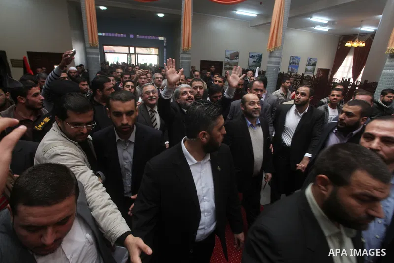 Hamas chief Khaled Meshaal, is greeted during his visit to the Islamic University in Gaza City December 9, 2012. Meshaal, in a defiant speech during his first ever visit to Gaza, told a mass rally on Saturday he would ne...