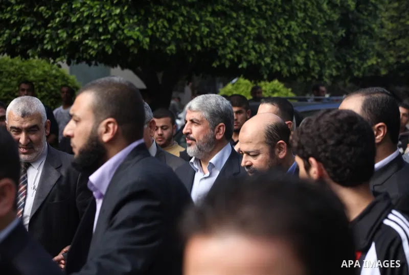 Hamas chief Khaled Meshaal, is greeted during his visit to the Islamic University in Gaza City December 9, 2012. Meshaal, in a defiant speech during his first ever visit to Gaza, told a mass rally on Saturday he would ne...