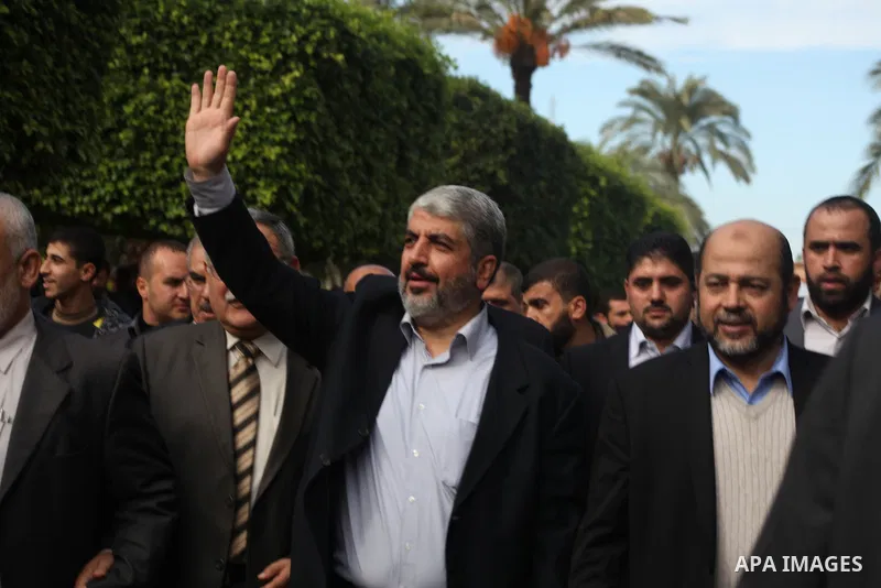 Hamas chief Khaled Meshaal, is greeted during his visit to the Islamic University in Gaza City December 9, 2012. Meshaal, in a defiant speech during his first ever visit to Gaza, told a mass rally on Saturday he would ne...