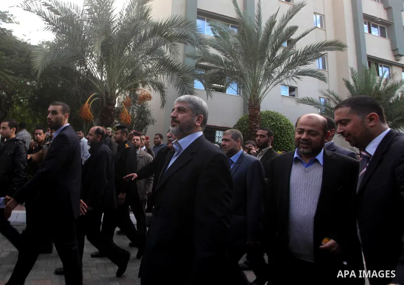 Hamas chief Khaled Meshaal, is greeted during his visit to the Islamic University in Gaza City December 9, 2012. Meshaal, in a defiant speech during his first ever visit to Gaza, told a mass rally on Saturday he would ne...