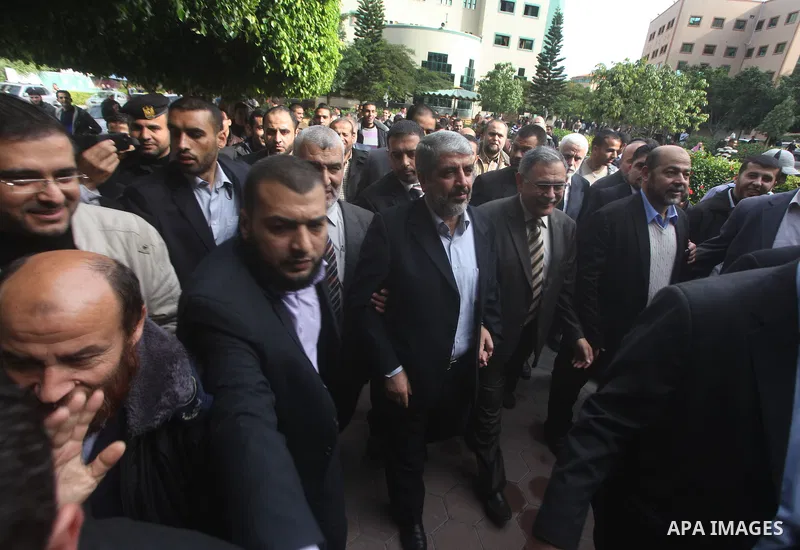 Hamas chief Khaled Meshaal, is greeted during his visit to the Islamic University in Gaza City December 9, 2012. Meshaal, in a defiant speech during his first ever visit to Gaza, told a mass rally on Saturday he would ne...