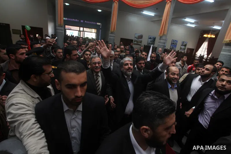 Hamas chief in exile Khaled Meshaal, waves at supporters during a visit to the Islamic University in Gaza City on December 9, 2012. Meshaal rejected ceding "an inch" of Palestinian territory to Israel or recognising the...
