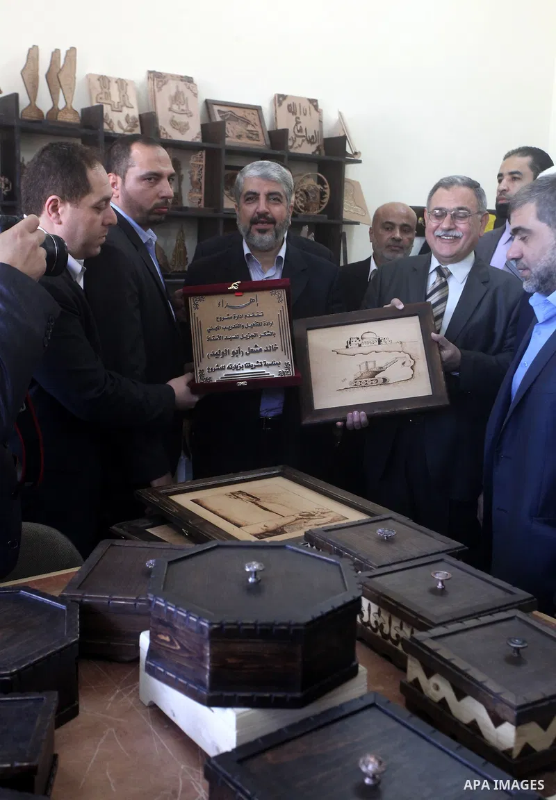 Hamas chief Khaled Meshaal, is greeted during his visit to a project funded by the Turkish President ragab ardogan in the Islamic University in Gaza City December 9, 2012. Meshaal, in a defiant speech during his first ev...
