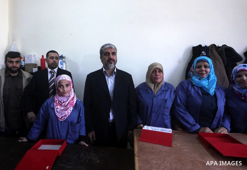 Hamas chief Khaled Meshaal, is greeted during his visit to a project funded by the Turkish President ragab ardogan in the Islamic University in Gaza City December 9, 2012. Meshaal, in a defiant speech during his first ev...