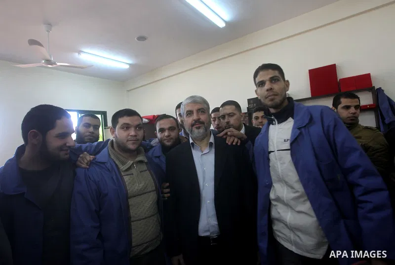 Hamas chief Khaled Meshaal, is greeted during his visit to a project funded by the Turkish President ragab ardogan in the Islamic University in Gaza City December 9, 2012. Meshaal, in a defiant speech during his first ev...