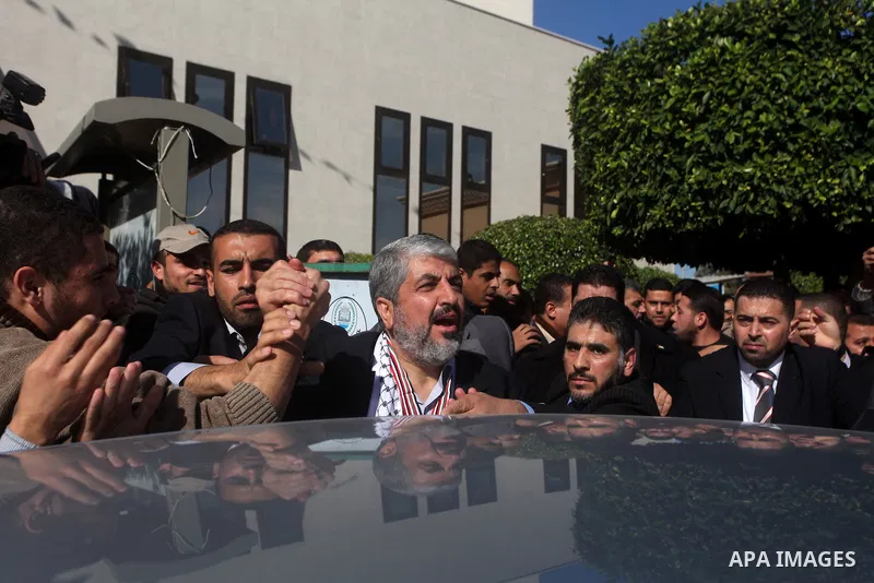Hamas chief in exile Khaled Meshaal, waves at supporters during a visit to the Islamic University in Gaza City on December 9, 2012. Meshaal rejected ceding "an inch" of Palestinian territory to Israel or recognising the...
