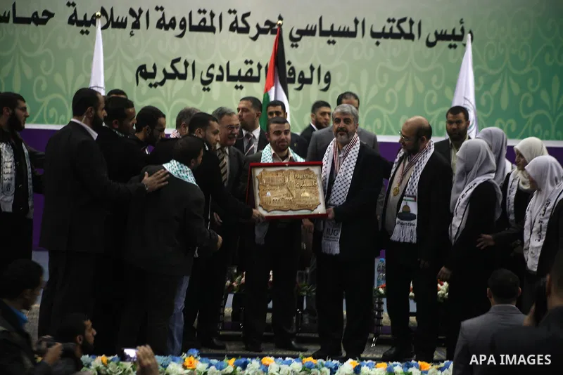 Hamas chief in exile Khaled Meshaal, waves at supporters during a visit to the Islamic University in Gaza City on December 9, 2012. Meshaal rejected ceding "an inch" of Palestinian territory to Israel or recognising the...