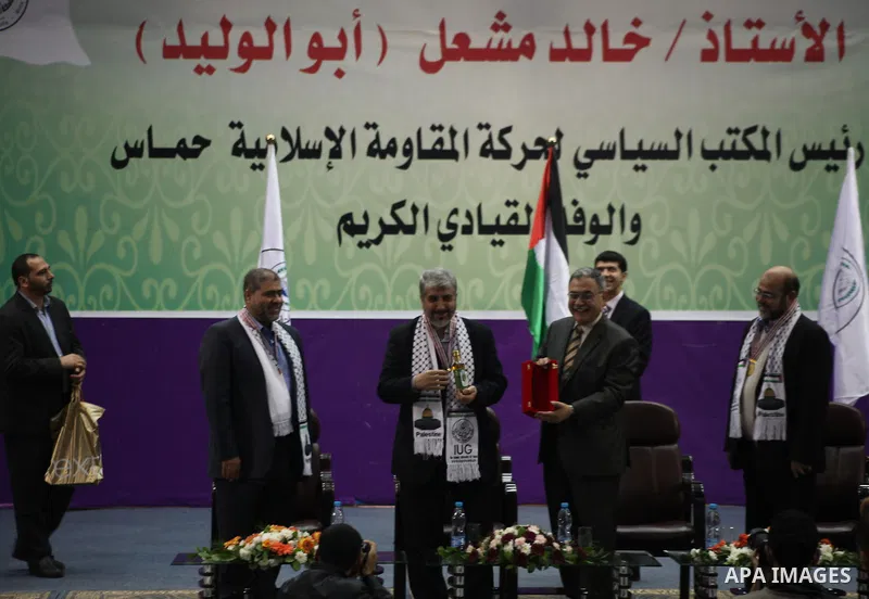 Hamas chief in exile Khaled Meshaal, waves at supporters during a visit to the Islamic University in Gaza City on December 9, 2012. Meshaal rejected ceding "an inch" of Palestinian territory to Israel or recognising the...
