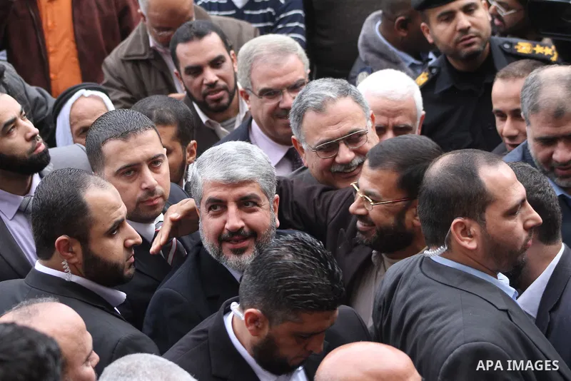 Hamas chief in exile Khaled Meshaal, waves at supporters during a visit to the Islamic University in Gaza City on December 9, 2012. Meshaal rejected ceding "an inch" of Palestinian territory to Israel or recognising the...