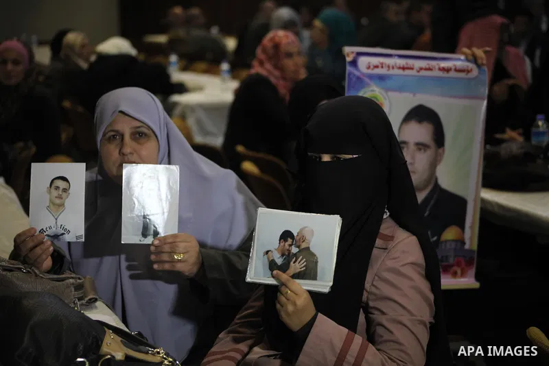 Hamas chief Khaled Meshaal (not seen), attends a meeting with the relatives of Palestinian prisoners in Israeli jails in Gaza City December 9, 2012. Meshaal, in a defiant speech during his first ever visit to Gaza, told...