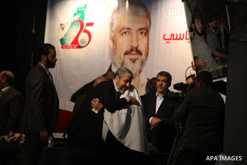 Hamas chief Khaled Meshaal, is greeted by a woman during a meeting with the relatives of Palestinian prisoners in Israeli jails in Gaza City December 9, 2012. Meshaal, in a defiant speech during his first ever visit to G...