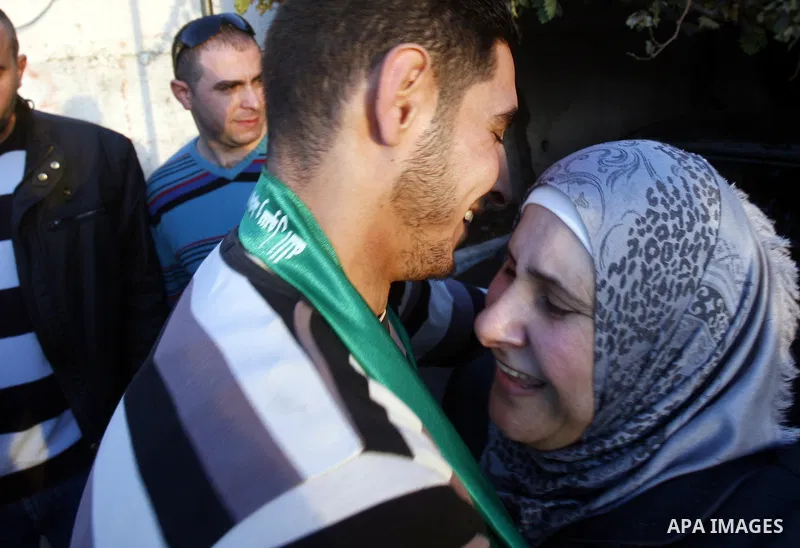 Palestinians celebrate after the Israeli authorities released prisoner Obaida al-Tawil in neighborhood of Bab al- Amood in Jerusalem on December 9, 2012. Al-Tawil spent 2 years in prison before the Israeli authorities re...