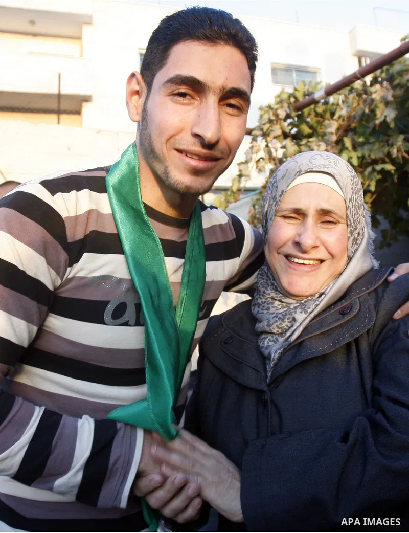Palestinians celebrate after the Israeli authorities released prisoner Obaida al-Tawil in neighborhood of Bab al- Amood in Jerusalem on December 9, 2012. Al-Tawil spent 2 years in prison before the Israeli authorities re...