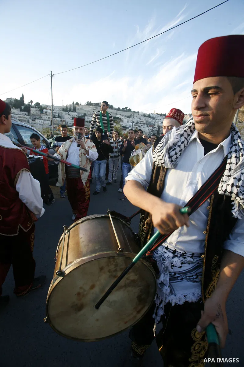 Palestinians celebrate after the Israeli authorities released prisoner Obaida al-Tawil in neighborhood of Bab al- Amood in Jerusalem on December 9, 2012. Al-Tawil spent 2 years in prison before the Israeli authorities re...