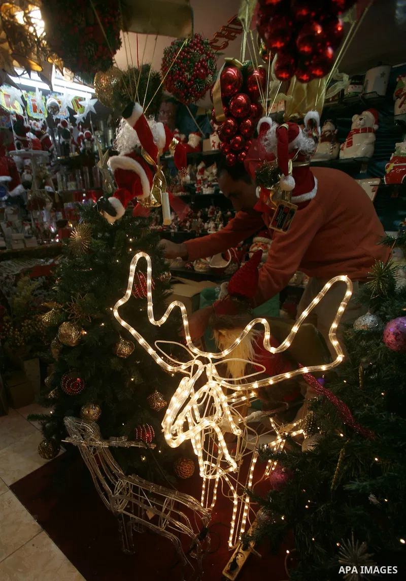 A Palestinian vendor decorates his store for the upcoming Christmas festivities in Jerusalem's old city, December 9, 2012. Christmas is celebrated across the globe on December 25 every year. Photo by Mahfouz Abu Turk