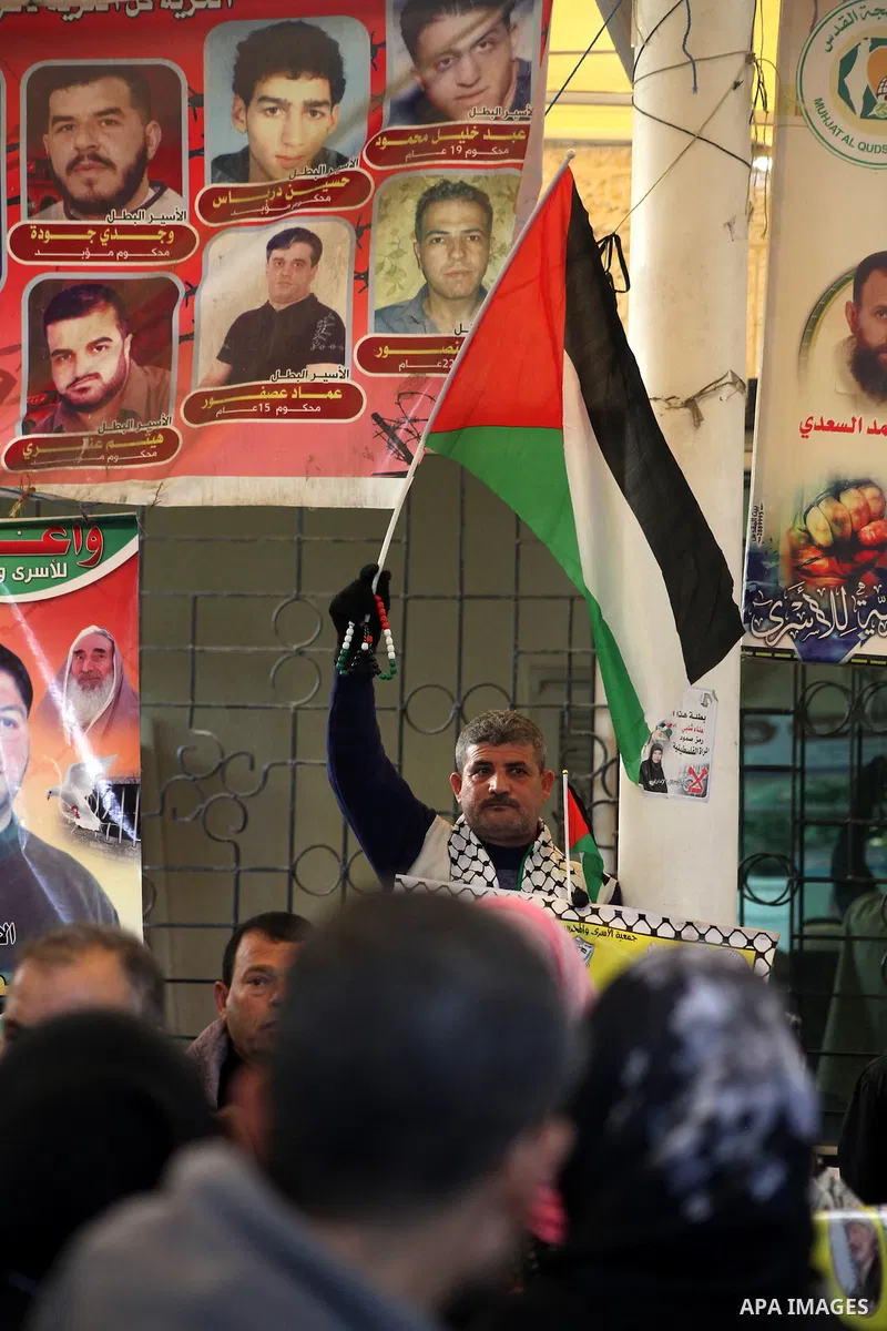 Palestinian women hold pictures of their prisoner relatives in Israeli jails as they gather in a weekly activity calling for their liberty at the Red Cross headquarters in Gaza City on December 10, 2012. Photo by Ashraf...