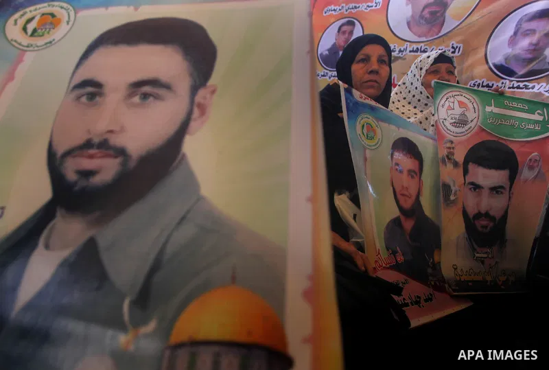 Palestinian women hold pictures of their prisoner relatives in Israeli jails as they gather in a weekly activity calling for their liberty at the Red Cross headquarters in Gaza City on December 10, 2012. Photo by Ashraf...