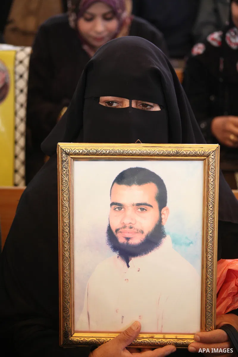 Palestinian women hold pictures of their prisoner relatives in Israeli jails as they gather in a weekly activity calling for their liberty at the Red Cross headquarters in Gaza City on December 10, 2012. Photo by Ashraf...