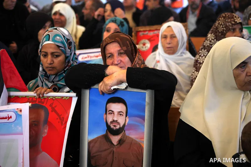 Palestinian women hold pictures of their prisoner relatives in Israeli jails as they gather in a weekly activity calling for their liberty at the Red Cross headquarters in Gaza City on December 10, 2012. Photo by Ashraf...