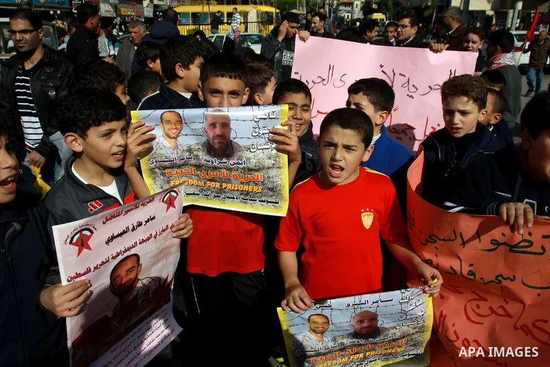 Palestinian children hold pictures of their prisoner relatives in Israeli jails as they gather in a weekly activity calling for their liberty in the West Bank City of Nablus on December 10, 2012. Photo by Nedal Eshtayah