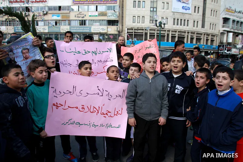 Palestinian children hold pictures of their prisoner relatives in Israeli jails as they gather in a weekly activity calling for their liberty in the West Bank City of Nablus on December 10, 2012. Photo by Nedal Eshtayah