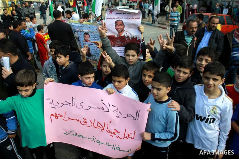 Palestinian children hold pictures of their prisoner relatives in Israeli jails as they gather in a weekly activity calling for their liberty in the West Bank City of Nablus on December 10, 2012. Photo by Nedal Eshtayah