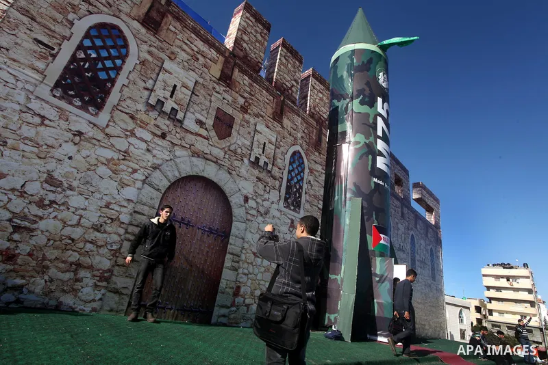 Palestinians take pictures in front of a gigantic model of a locally made M75 rocket in Gaza city, December 10, 2012. Hamas chief Khaled Meshaal arrived on December 7 during his first-ever visit to the Gaza Strip amid ti...