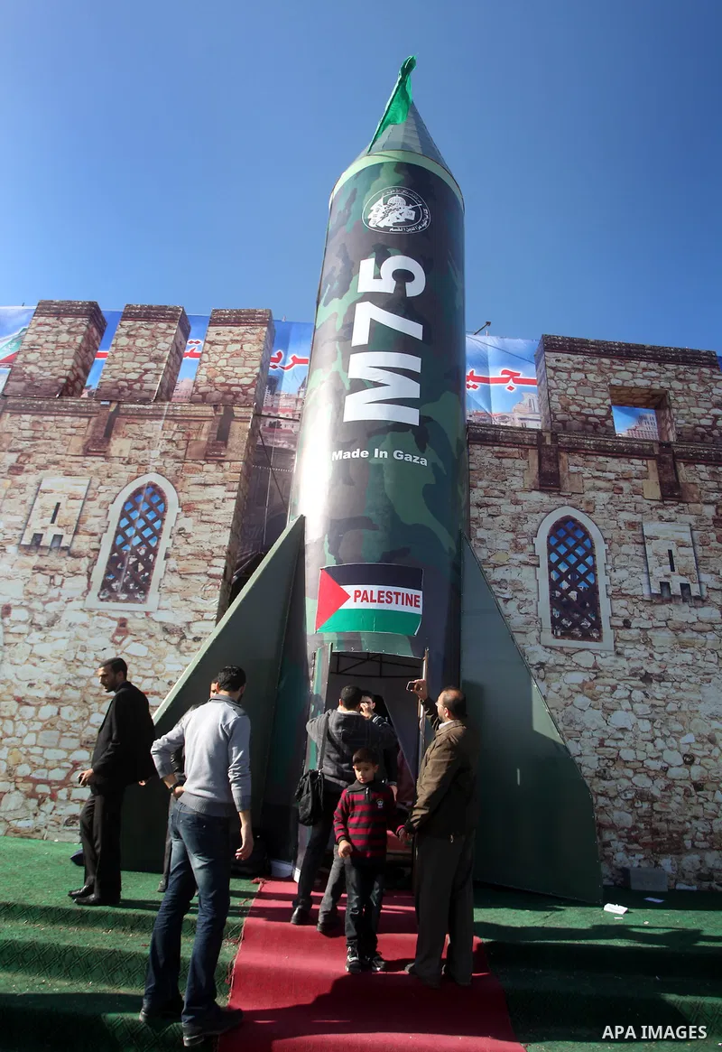 Palestinians take pictures in front of a gigantic model of a locally made M75 rocket in Gaza city, December 10, 2012. Hamas chief Khaled Meshaal arrived on December 7 during his first-ever visit to the Gaza Strip amid ti...
