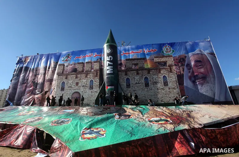 Palestinians take pictures in front of a gigantic model of a locally made M75 rocket in Gaza city, December 10, 2012. Hamas chief Khaled Meshaal arrived on December 7 during his first-ever visit to the Gaza Strip amid ti...