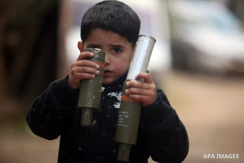 A Palestinian boy carries empty tear gas canister after an Israeli military incursion to village of Beit Liqya near the West Bank city of Ramallah, December 10, 2012. Photo by Issam Rimawi