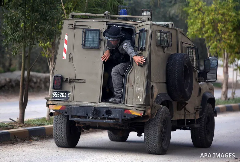 An Israeli soldier into his military vehicle during an Israeli military incursion to village of Beit Liqya near the West Bank city of Ramallah, December 10, 2012. Photo by Issam Rimawi