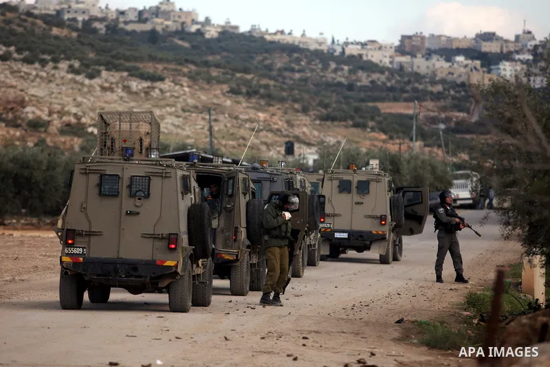Israeli soldiers walk during an Israeli military incursion to village of Beit Liqya near the West Bank city of Ramallah, December 10, 2012. Photo by Issam Rimawi