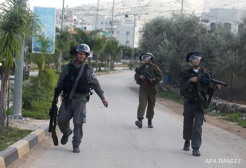 Israeli soldiers walk during an Israeli military incursion to village of Beit Liqya near the West Bank city of Ramallah, December 10, 2012. Photo by Issam Rimawi