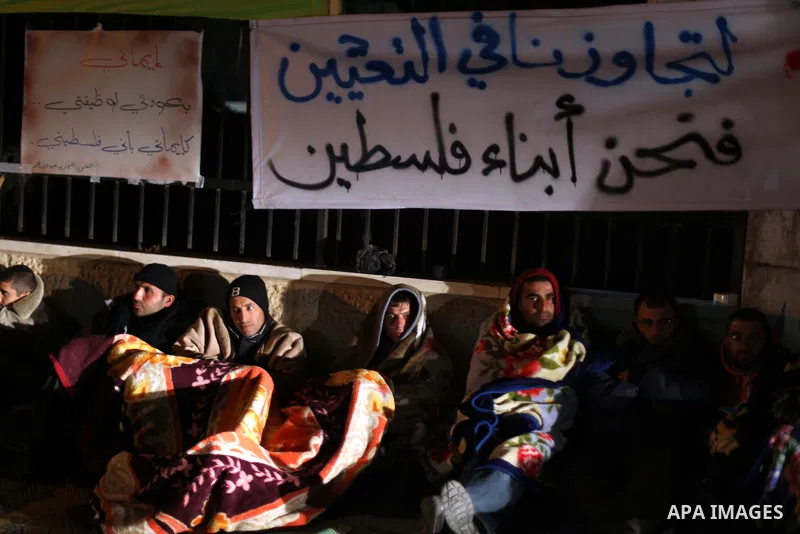 Palestinian teachers and graduates who were barred from employment by Ministry of Education, sit during a protest in front of Council of Ministers, in the West Bank city of Ramallah, December 10, 2012. Photo by Issam Rim...