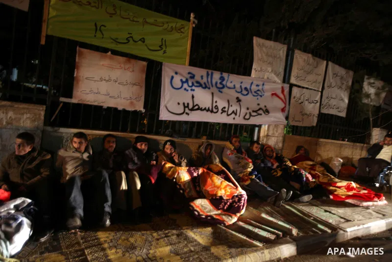 Palestinian teachers and graduates who were barred from employment by Ministry of Education, sit during a protest in front of Council of Ministers, in the West Bank city of Ramallah, December 10, 2012. Photo by Issam Rim...
