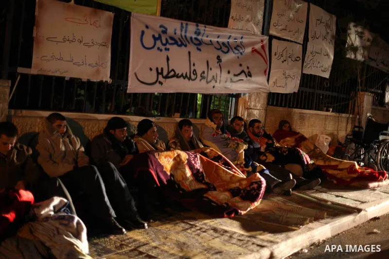 Palestinian teachers and graduates who were barred from employment by Ministry of Education, sit during a protest in front of Council of Ministers, in the West Bank city of Ramallah, December 10, 2012. Photo by Issam Rim...