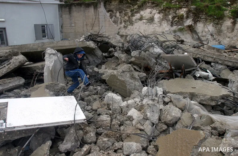 A Palestinian boy from Jabari family walks on the rubble of their house after it was demolished by Jerusalem municipality workers in the mostly Arab east Jerusalem neighborhood of al-Tur on December 11, 2012. Palestinian...