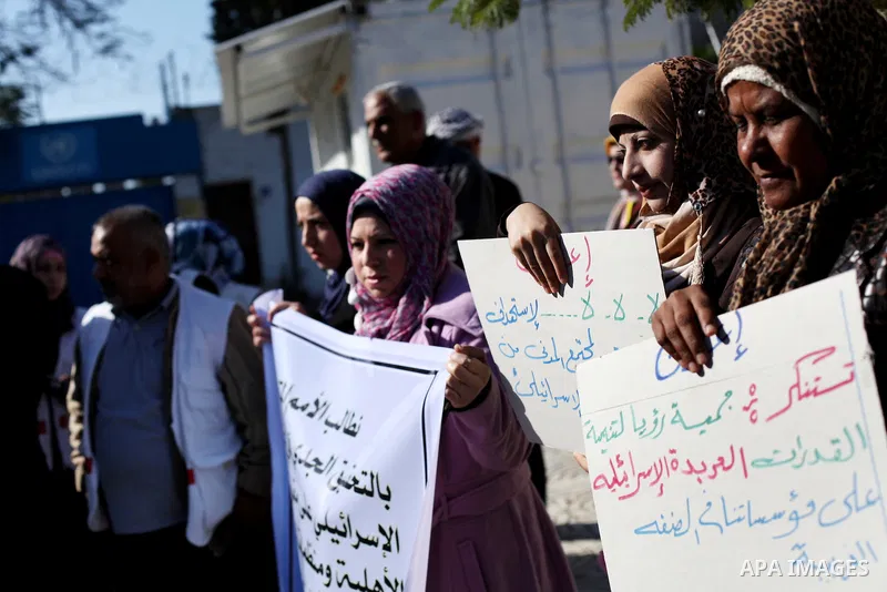 Palestinian employees of the Union of Health Work Committees protest to against Israeli attacks on the headquarters of the NGO network, in Gaza city, on Dec. 12, 2012. Photo by Ashraf Amra