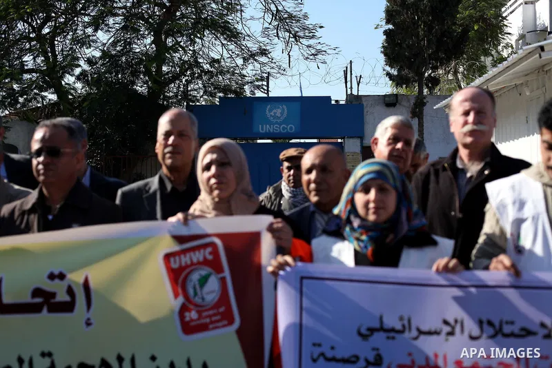 Palestinian employees of the Union of Health Work Committees protest to against Israeli attacks on the headquarters of the NGO network, in Gaza city, on Dec. 12, 2012. Photo by Ashraf Amra