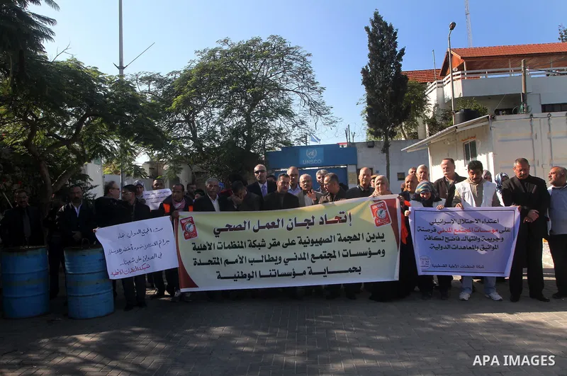 Palestinian employees of the Union of Health Work Committees protest to against Israeli attacks on the headquarters of the NGO network, in Gaza city, on Dec. 12, 2012. Photo by Ashraf Amra