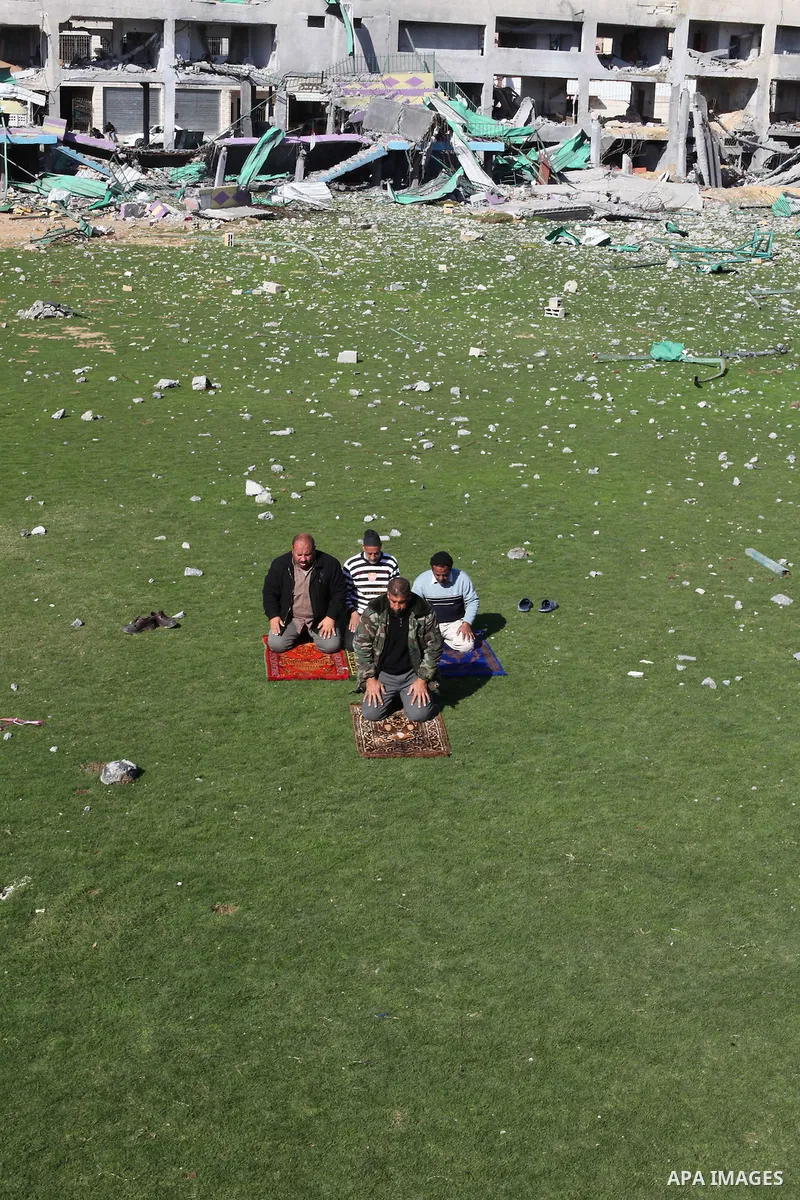 Palestinian security guards pray at a soccer stadium, which witnesses said was destroyed in an Israeli air strike during an eight-day conflict, in Gaza City December 4, 2012. Eight days of Israeli air strikes on Gaza and...