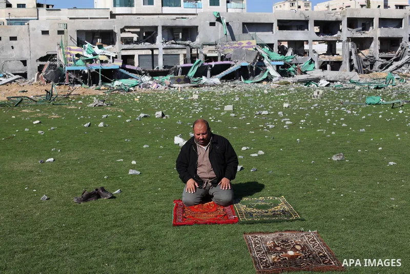 Palestinian security guards pray at a soccer stadium, which witnesses said was destroyed in an Israeli air strike during an eight-day conflict, in Gaza City December 4, 2012. Eight days of Israeli air strikes on Gaza and...